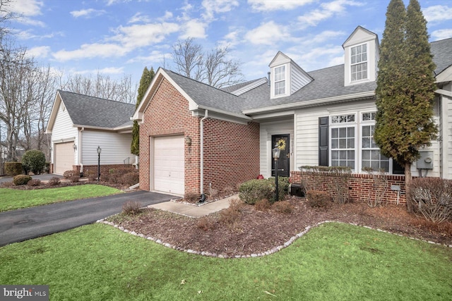 view of front facade with a garage and a front yard