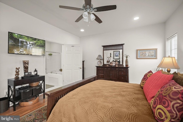 bedroom featuring ceiling fan, wood-type flooring, vaulted ceiling, and ensuite bathroom