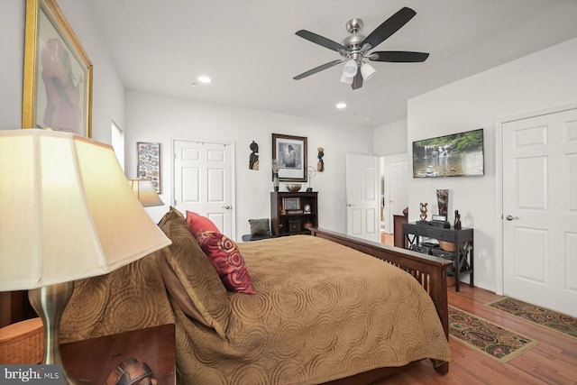 bedroom with wood-type flooring and ceiling fan