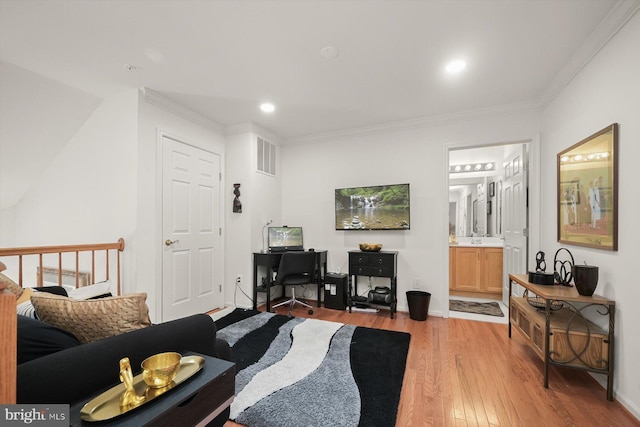 living room featuring crown molding, sink, and light hardwood / wood-style flooring