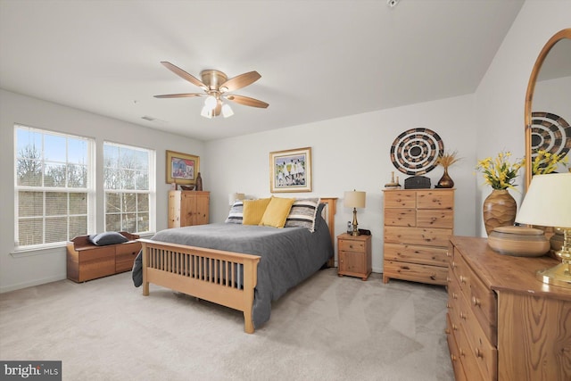 bedroom featuring light colored carpet and ceiling fan