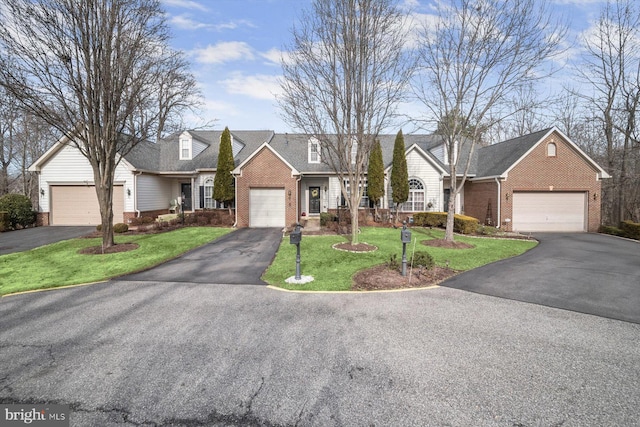 view of front of home featuring a garage and a front lawn