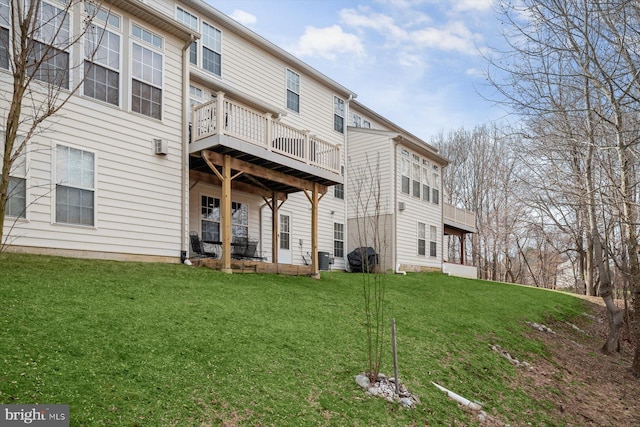 rear view of house featuring a lawn