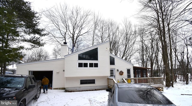 view of front facade with a garage and a chimney