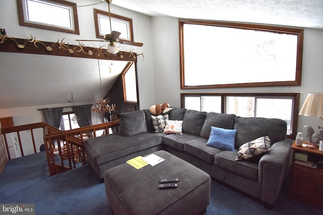 carpeted living room with lofted ceiling, a textured ceiling, and a ceiling fan