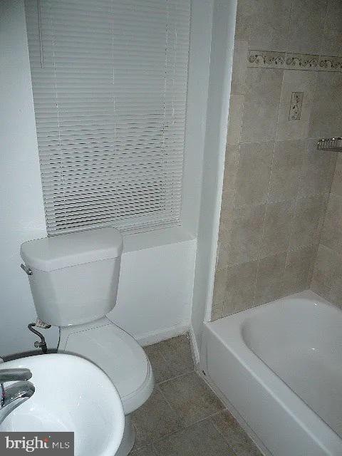 bathroom with tile patterned flooring and toilet