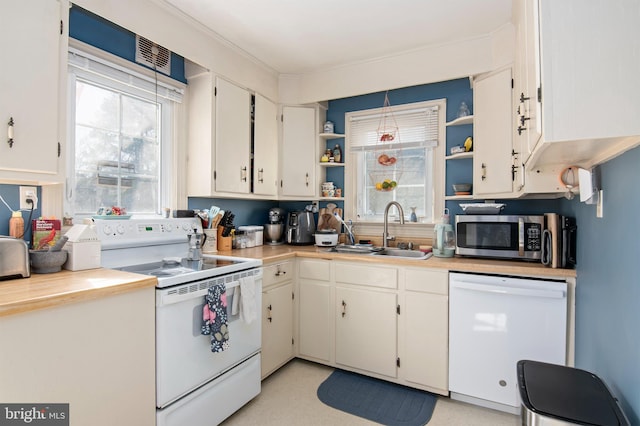 kitchen with open shelves, white appliances, a sink, and white cabinets