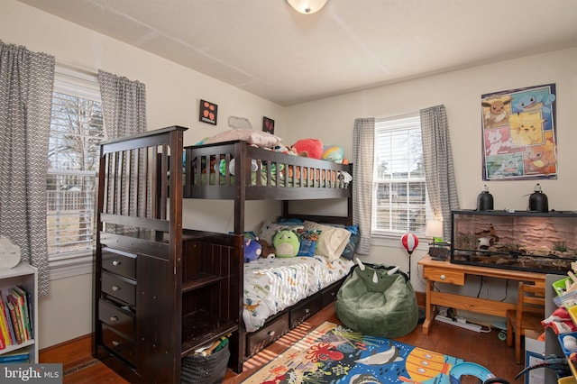 bedroom featuring baseboards and wood finished floors