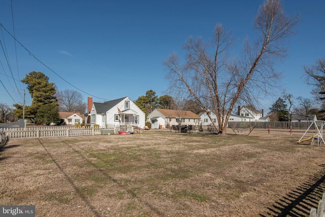 view of yard with a playground and a fenced backyard