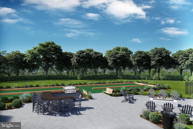 view of patio / terrace with an outdoor kitchen, a grill, and an outdoor fire pit