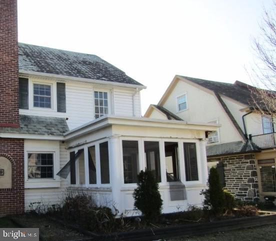 view of side of home with a sunroom