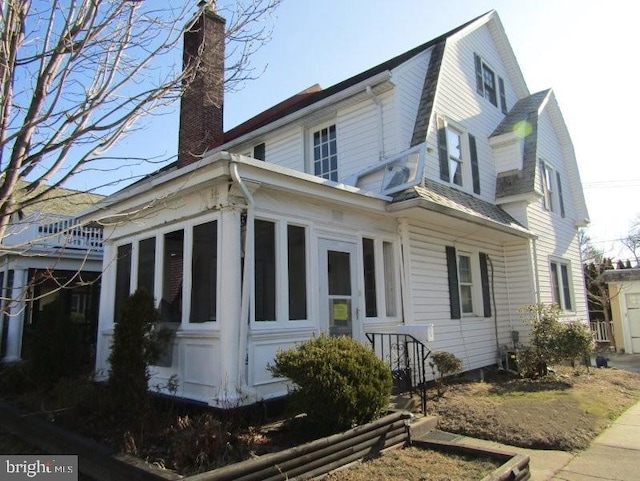 view of home's exterior with a sunroom