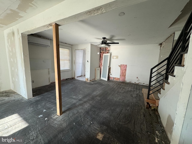 interior space featuring an AC wall unit and ceiling fan