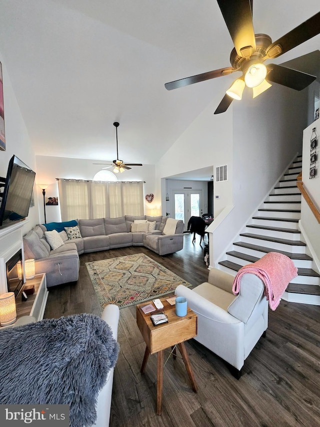 living room featuring ceiling fan, high vaulted ceiling, and dark hardwood / wood-style flooring