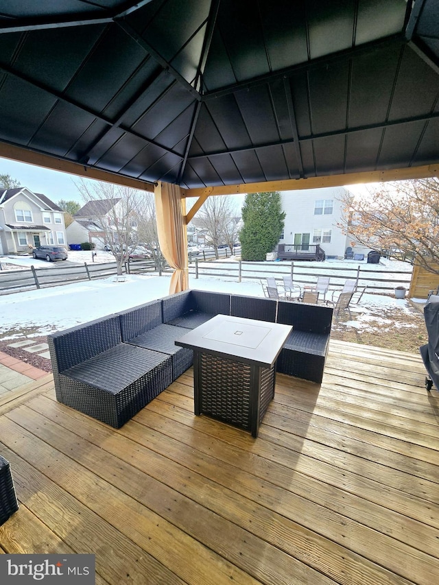 snow covered deck featuring a gazebo and an outdoor living space with a fire pit