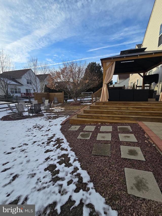 yard layered in snow with a fire pit