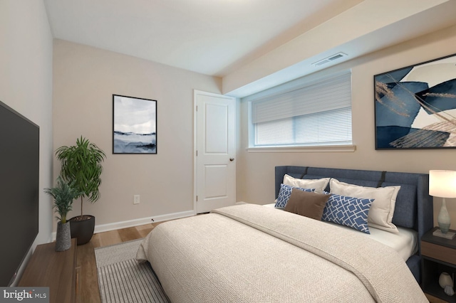 bedroom with hardwood / wood-style flooring