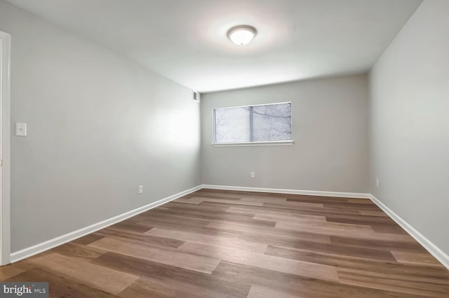 empty room with hardwood / wood-style flooring