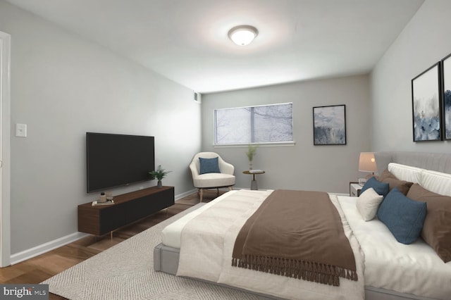 bedroom with dark wood-type flooring