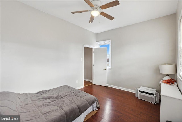 bedroom with dark hardwood / wood-style flooring and ceiling fan