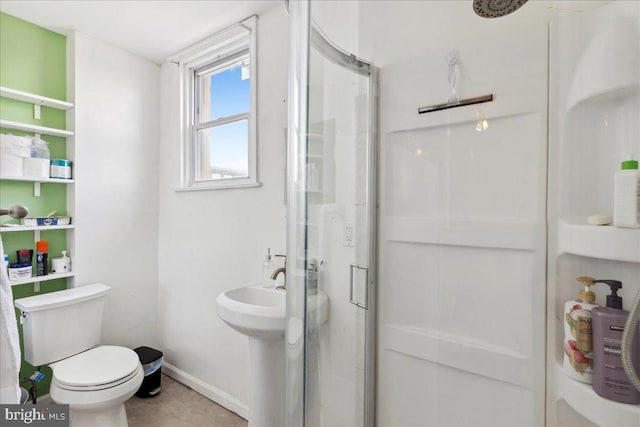 bathroom featuring walk in shower and toilet