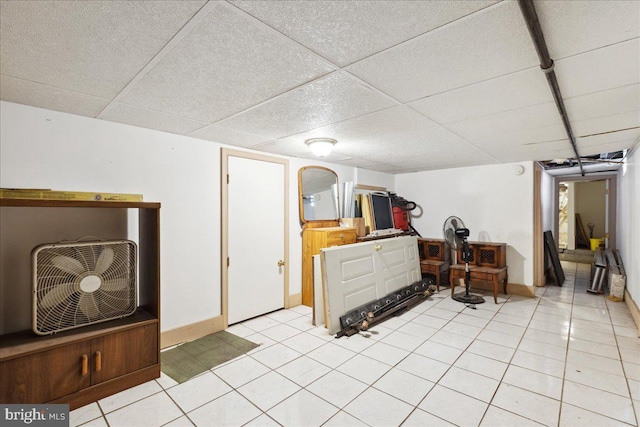 tiled bedroom with a paneled ceiling