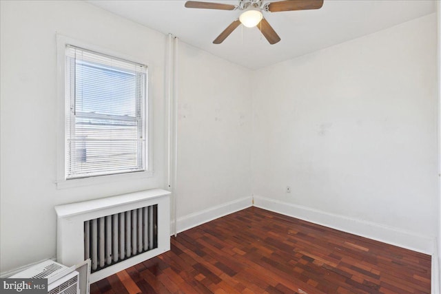 unfurnished room featuring ceiling fan, radiator heating unit, and dark hardwood / wood-style flooring