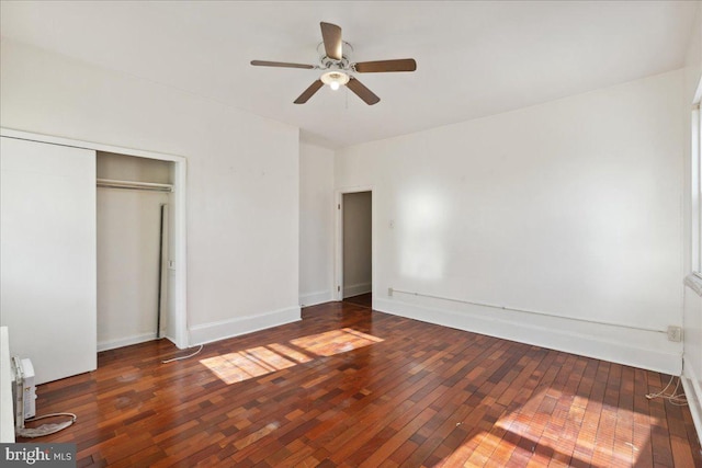 unfurnished bedroom with ceiling fan, dark hardwood / wood-style floors, and a closet