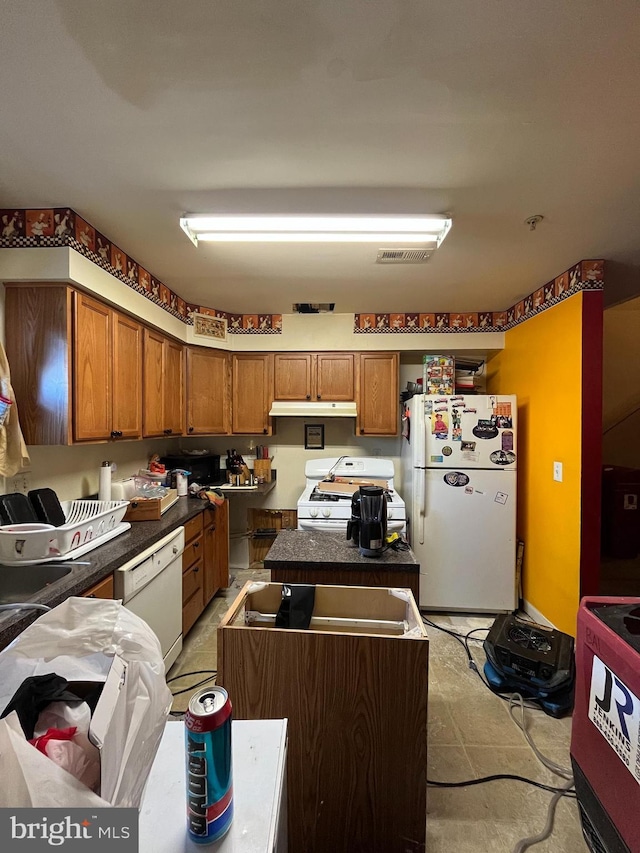 kitchen with white appliances and a kitchen island