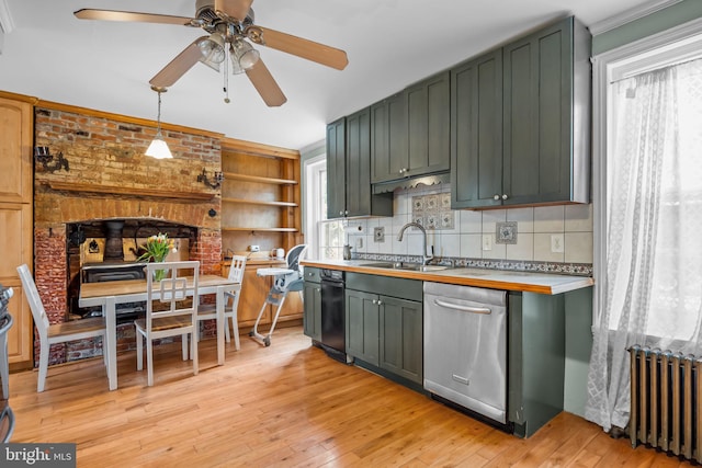 kitchen featuring pendant lighting, radiator, green cabinets, and dishwasher