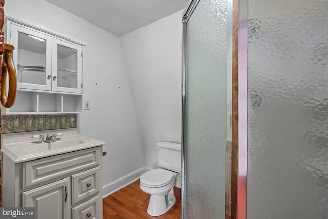 bathroom with vanity, an enclosed shower, hardwood / wood-style flooring, and toilet