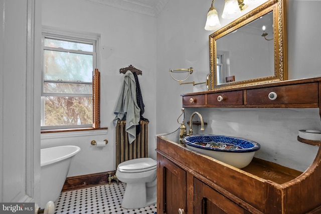 bathroom with vanity, a wealth of natural light, crown molding, and a tub to relax in