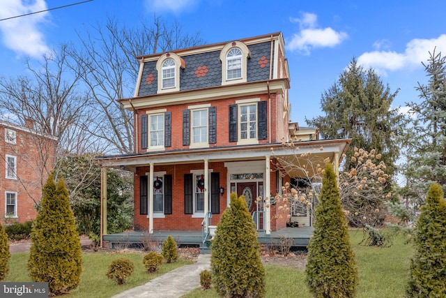 view of front of property with a porch and a front yard