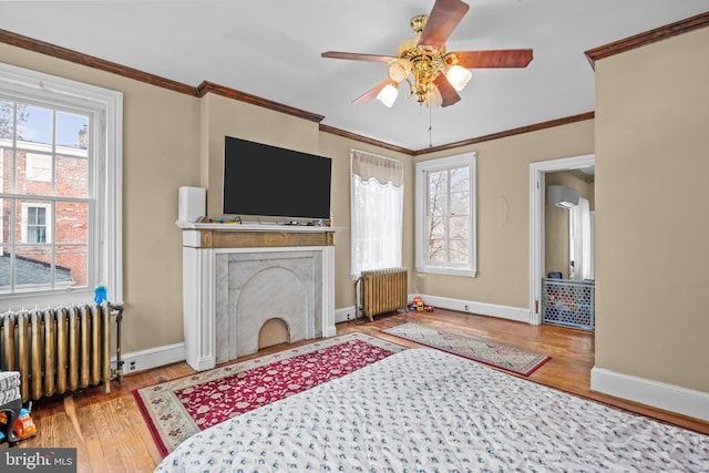 living room featuring a wealth of natural light, radiator heating unit, and ornamental molding