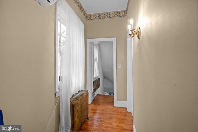 hall with radiator and light hardwood / wood-style floors