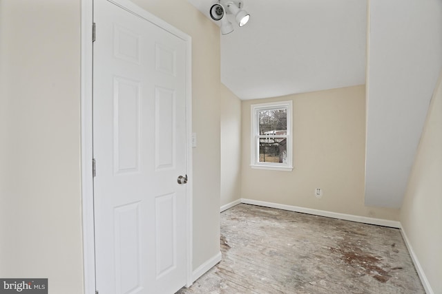 interior space featuring lofted ceiling and light hardwood / wood-style floors