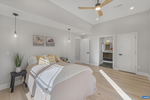 bedroom featuring hardwood / wood-style flooring and ensuite bathroom