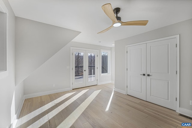 additional living space featuring light hardwood / wood-style flooring, french doors, and ceiling fan