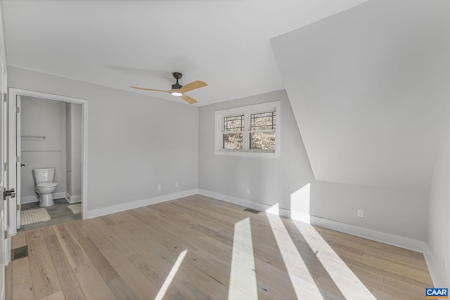 unfurnished bedroom featuring ceiling fan, connected bathroom, and light hardwood / wood-style floors