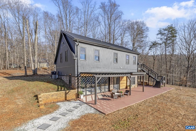 back of house with central air condition unit and a patio area