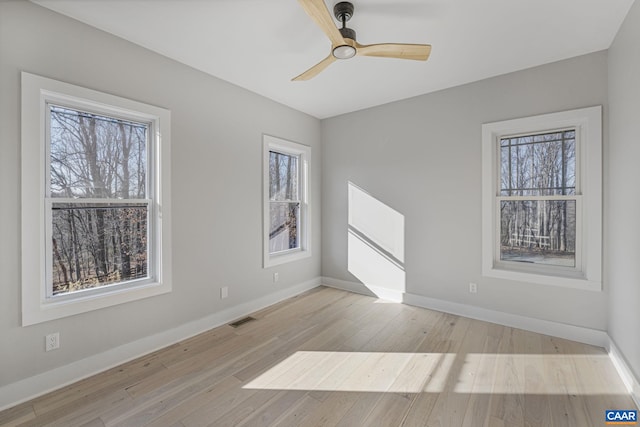 unfurnished room featuring ceiling fan and light wood-type flooring