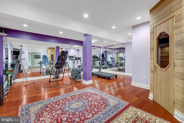 exercise room featuring recessed lighting, baseboards, and wood finished floors