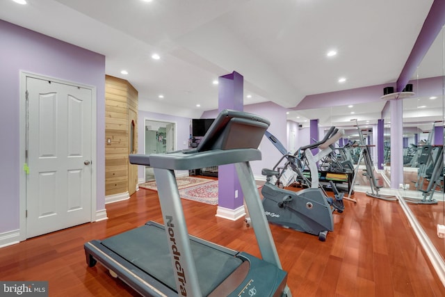 workout room with recessed lighting, baseboards, and wood finished floors