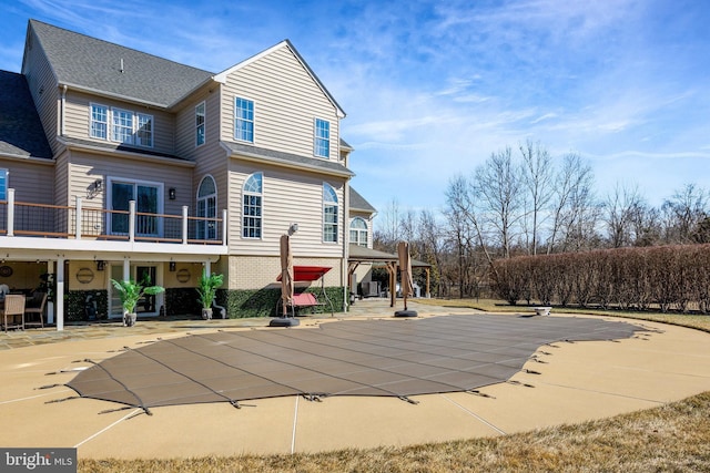 view of swimming pool with a patio area and a covered pool