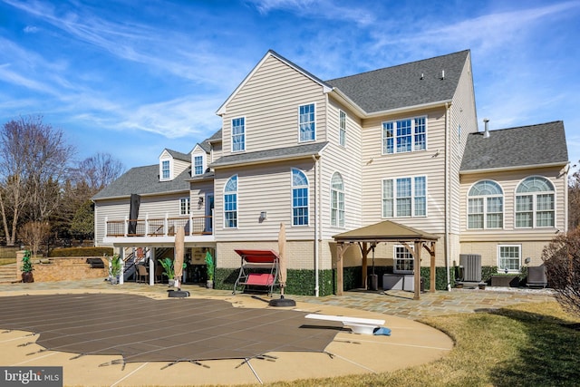 back of house with a deck, central air condition unit, a gazebo, stairway, and a patio area