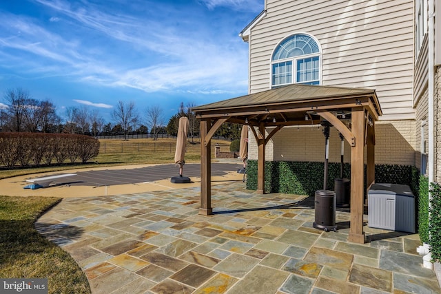 view of patio with fence and a gazebo