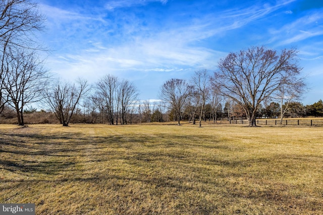 view of yard featuring a rural view and fence