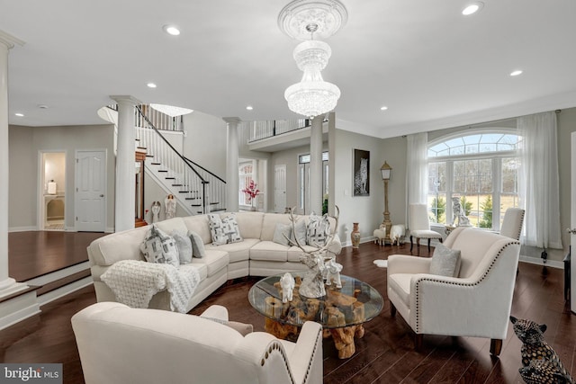 living room featuring baseboards, stairway, wood finished floors, ornate columns, and recessed lighting