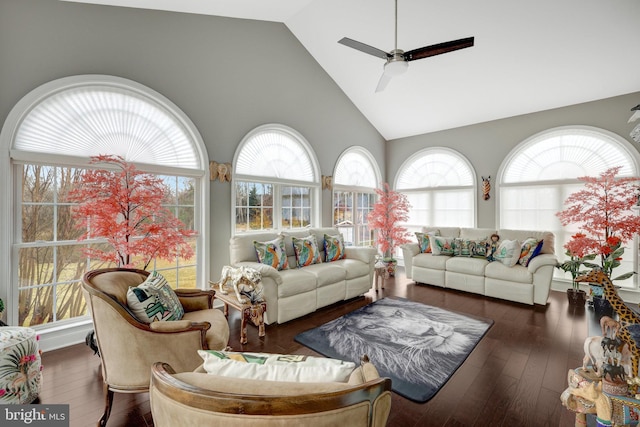 living room with a healthy amount of sunlight, hardwood / wood-style flooring, ceiling fan, and high vaulted ceiling