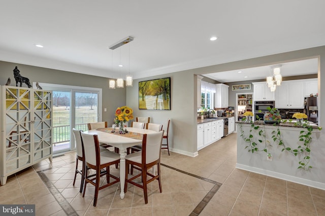 dining room with recessed lighting, plenty of natural light, light tile patterned flooring, and baseboards